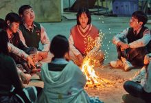 The cast “All of us are Dead” gathered around a fire.